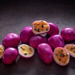 Chocolate-coated freeze-dried passionfruit with dragon fruit purple coating made by Noosa Chocolate Factory