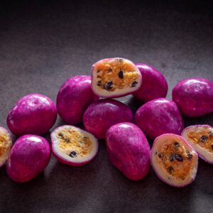 Chocolate-coated freeze-dried passionfruit with dragon fruit purple coating made by Noosa Chocolate Factory
